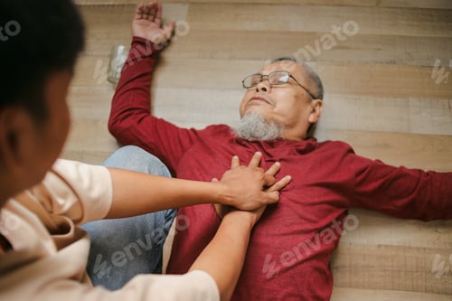 Preview: Elderly Man Laying Down With Cardiac Arrest Helped By Person Doing Emergency Cpr At Home