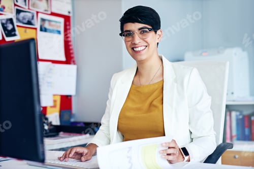 Preview: My business plan is coming together. Portrait of a young businesswoman working at her desk.