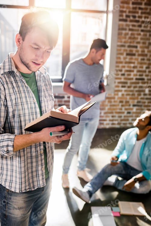 Preview: young professionals working on new business project in small business office