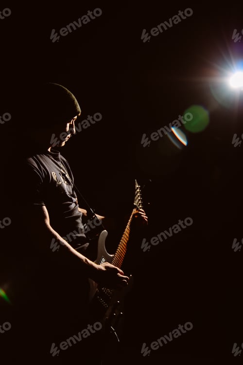 Preview: the guy plays the guitar in the dark with one spotlight