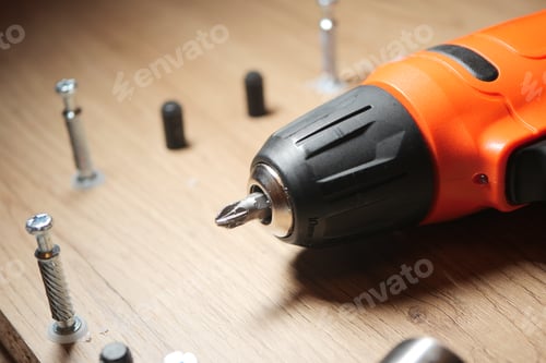 Preview: Power drill used for assembling furniture on a wooden surface