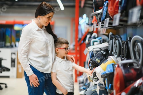 Preview: Mother and son shopping for electric vacuum cleaner, smiling