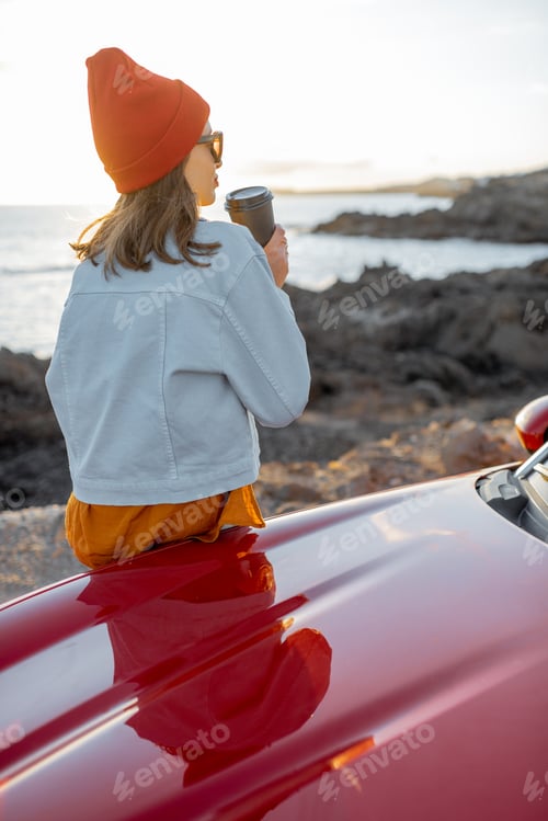 Preview: Woman traveling by car on the rocky coastline