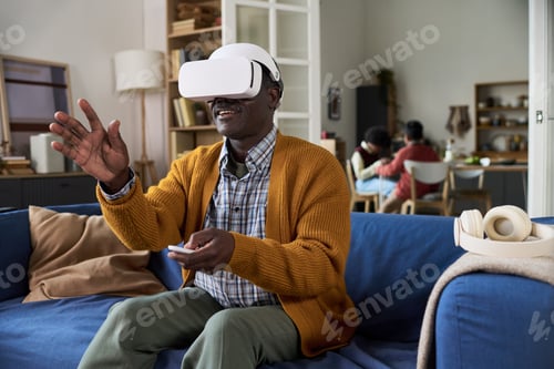 Preview: Mature Black Man Experiencing Virtual Reality Technology at Home
