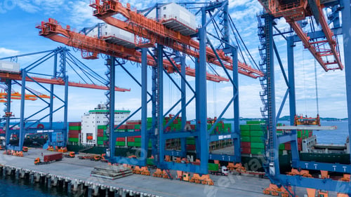Preview: crane loading cargo container from truck to container ship in the international terminal