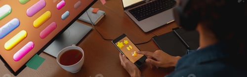 Preview: Woman graphic designer is using smartphone during work day in home office