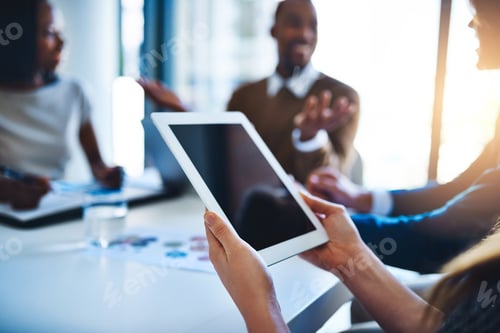 Preview: Shot of an unidentifiable businesswoman holding a tablet during a meeting in the office