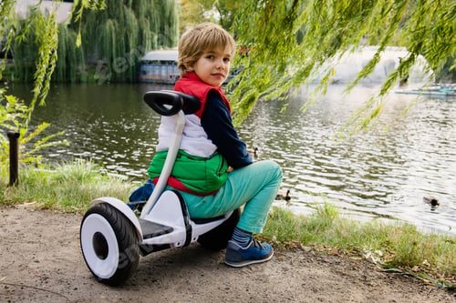 Preview: Boy on his new electronic hoverboard in the city outdoors