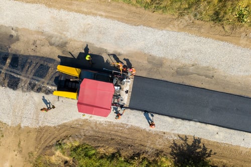 Preview: Aerial view of new road construction with asphalt laying machinery at work