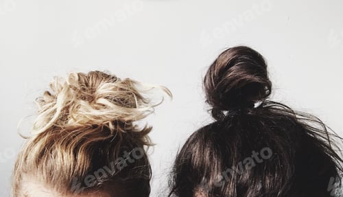 Preview: Two Women Showing Hairstyle Buns Inside a Room