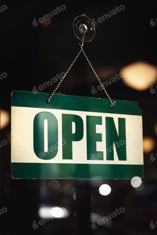 Preview: Closeup of an OPEN sign hanging on glass door