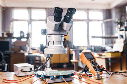 Preview: Modern microscope, connectors component and large green microcircuit in workshop laboratory