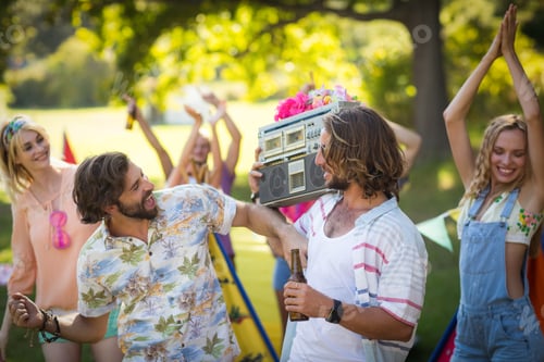 Preview: Group of friends having fun together at campsite