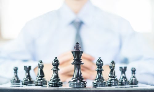 Preview: hand of businessmen moving chess in competition shows leadership, followers and business success
