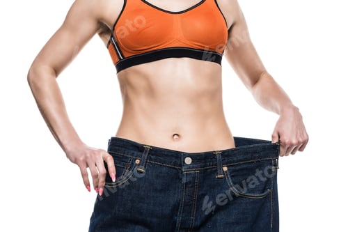 Preview: cropped view of sportswoman wearing oversized jeans to show her slim body isolated on white