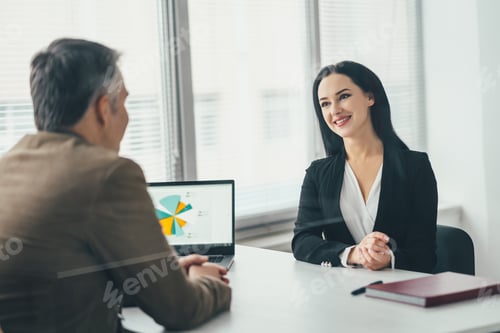 Preview: The business woman and a man talking at the office table