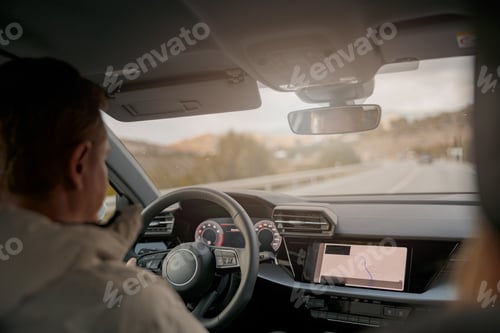 Preview: Rear of man driver driving a car, shot from inside the car, traveling in automobile
