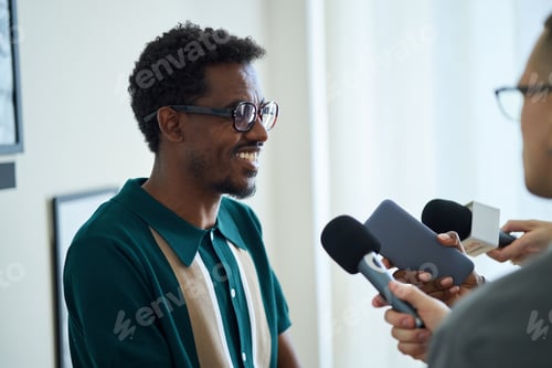 Preview: Smiling Man Giving Interview and Holding Microphone