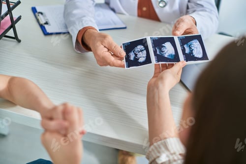 Preview: lesbian couple taking ultrasound of their baby from gynecologist, in vitro fertilization concept