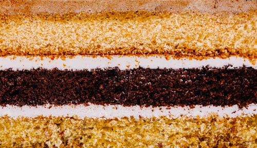 Preview: Delicious layered cake with white frosting showing its texture