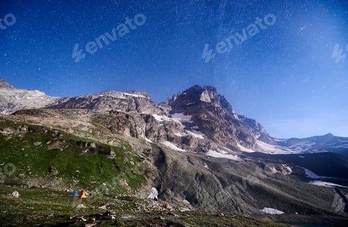 Preview: Night starry sky over Matterhorn, Monte Cervino mountain.