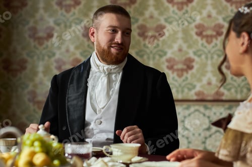 Preview: Bearded Gentleman Smiling at Lady During Tea Party