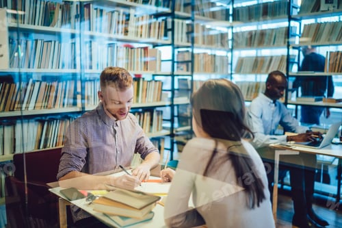 Preview: Students working on project in library