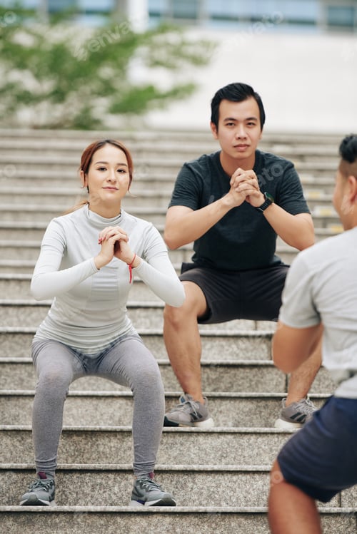Preview: Couple doing squats on steps
