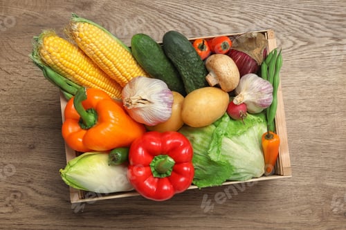 Preview: Crate with different fresh vegetables on wooden background, top view