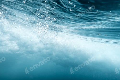 Preview: Underwater View of Wave Crashing to Shore Spraying Drops of Water Across the Sea