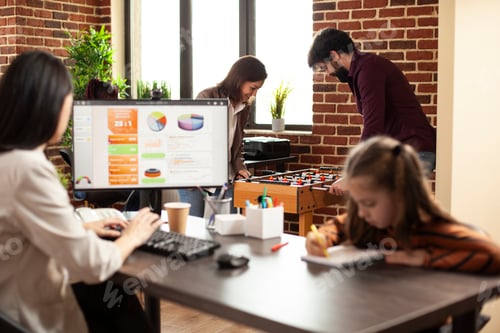 Preview: Colleagues work and play in office space