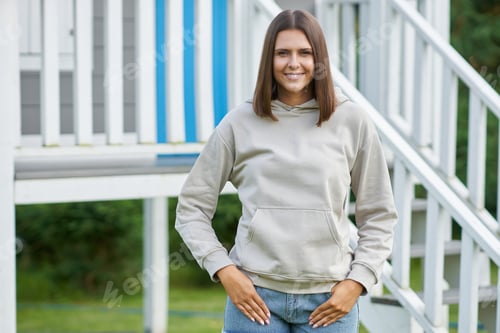 Preview: Young woman in beige hoodie.
