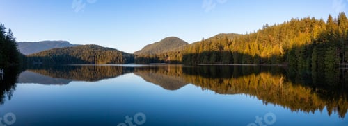 Preview: Vibrant panoramic view of a lake surounded by Canadian Mountain Landscape