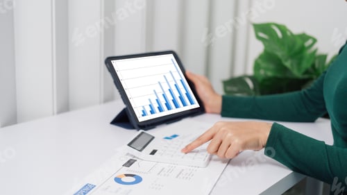 Preview: Young Asian household woman busy with bills and taxation, using calculator, make payment on tablet