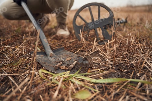 Preview: Man found old bullets and coin, sapper, close up view, with shovel