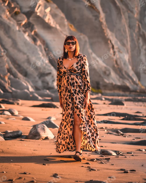 Preview: Summer street style on a beach next to rocks of a young brunette caucasian woman