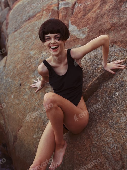 Preview: Summer Siren: A Sensual Swimwear Model Posing on a Gorgeous Beach Rock, Embracing the Ocean Bliss
