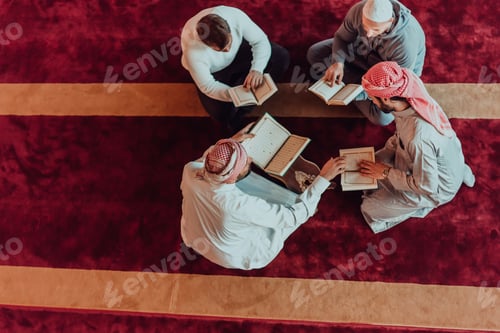 Preview: A group of Muslims reading the holy book of the Quran in a modern mosque during the Muslim holiday