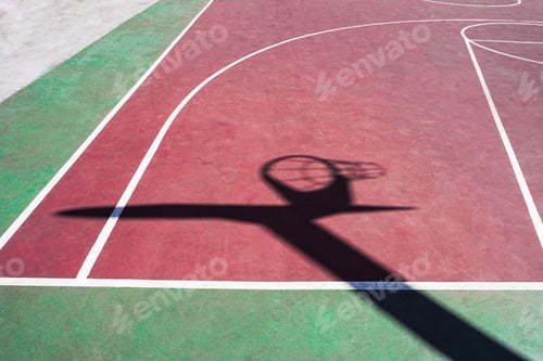 Preview: Outdoor basketball court with a shadow of hoop on the ground