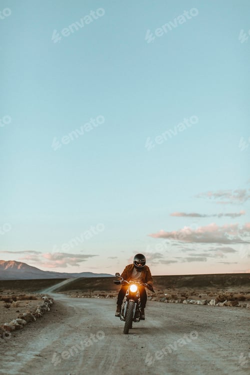Preview: Motorcyclist riding in desert, Trona Pinnacles, California, US