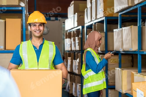 Preview: Idian worker man holding cardboard box and walking with Muslim worker woman scanning bar code