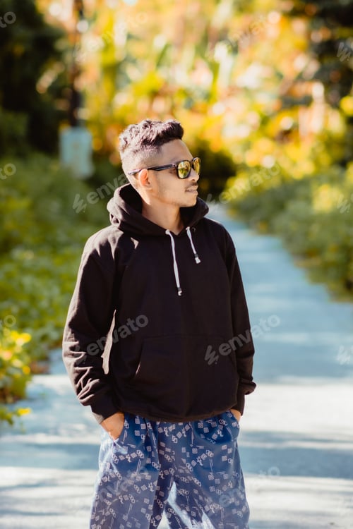 Preview: Young man with hoodie standing in outdoor in summer