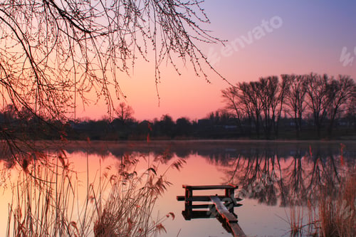 Preview: The first rays of the rising sun at misty river