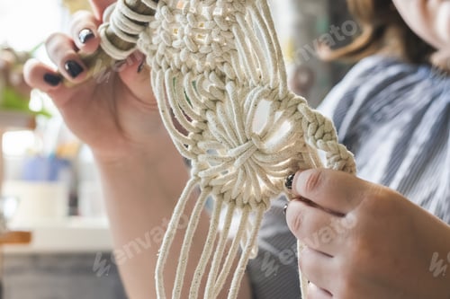 Preview: Female hands weave macrame home workshop. Boho lifestyle. Hobby hobby concept