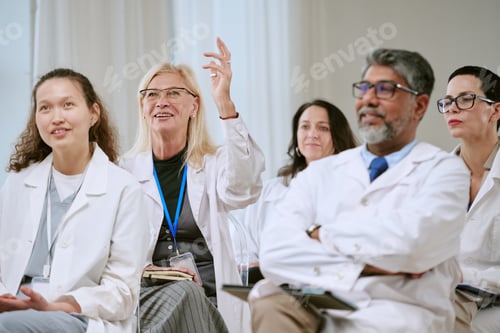 Preview: Senior Woman Doctor Asking Question during Multiethnic Seminar