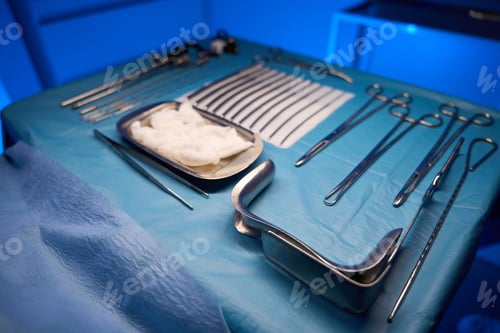 Preview: Surgical Instruments and Supplies on Blue Tablecloth