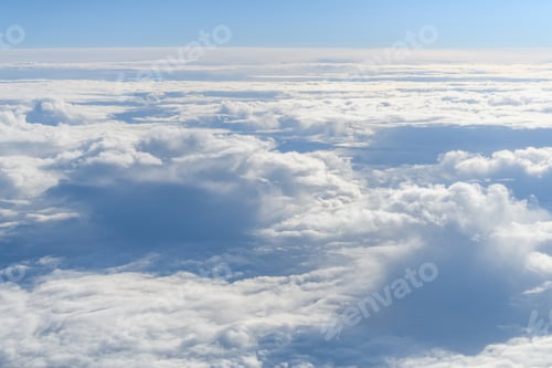 Preview: Clouds and sky as seen through window of an aircraft