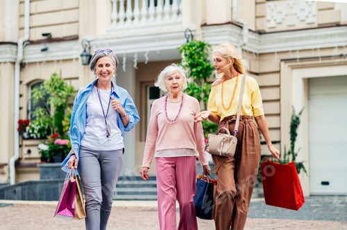Preview: Beautiful happy senior women shopping in the city centre
