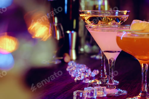 Preview: Two beautiful cocktails served on a wooden bar counter