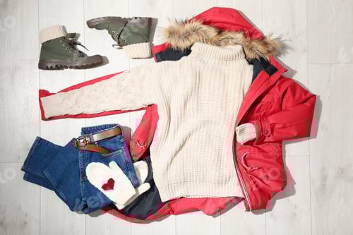 Preview: Set of stylish winter outfit on wooden background, flat lay